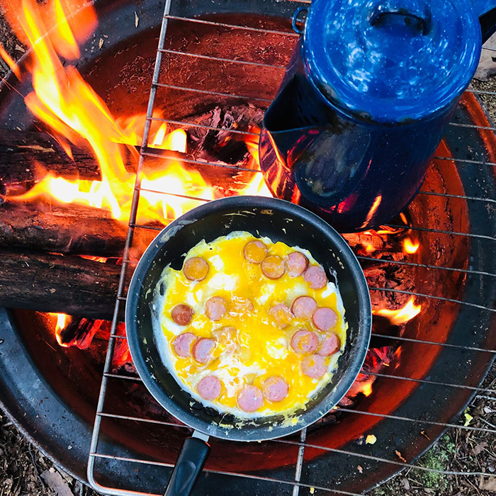 egg dish cooking over campfire